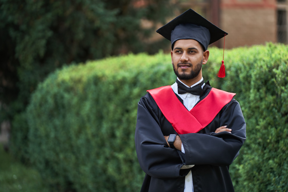 serious-indian-graduate-graduation-robe-with-crossed-arms-looking-forward
